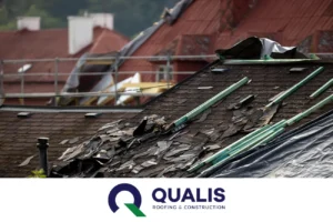 Roof damaged by weather with missing shingles and tarps, with "qualis roofing & construction" logo visible below.